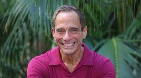 Photo of Harvey Levin visiting a park by wearing pink vest.